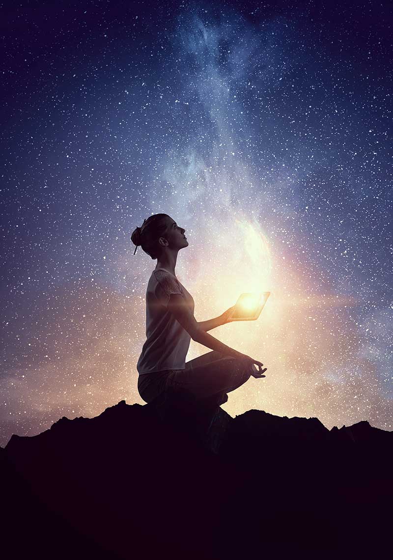 Woman meditating under the stars